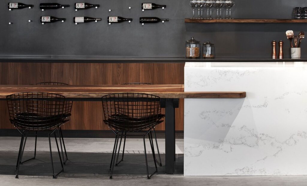 White quartz waterfall countertop with dark wood cabinets in Calgary