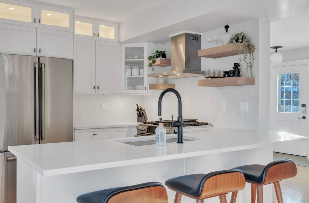 Quartz countertops Calgary kitchen project with a white island and black faucet