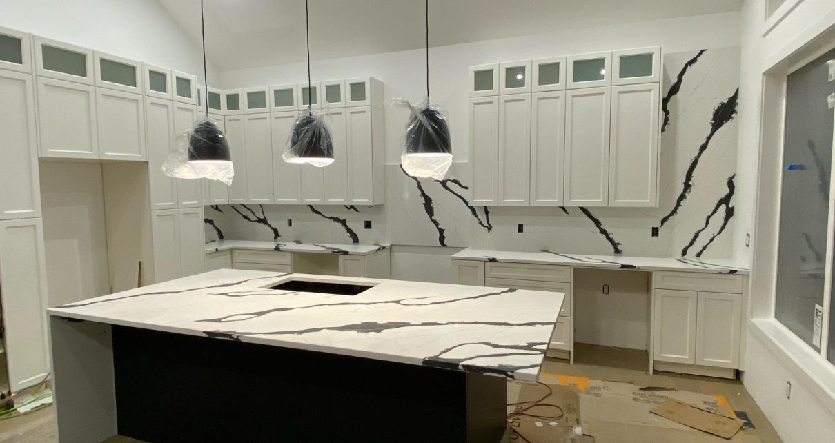 Custom quartz kitchen island and full-height backsplash in Calgary