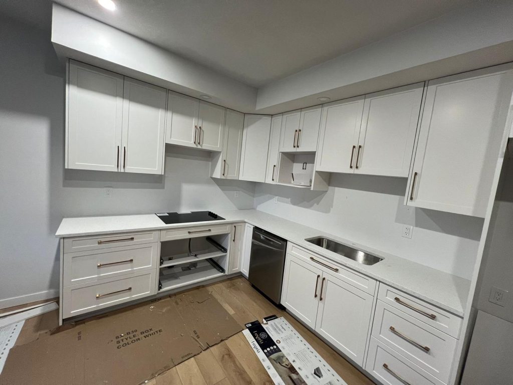White quartz kitchen countertops with sink and cooktop cutouts in Calgary