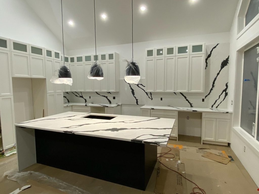 Quartz kitchen countertops and full-height backsplash installation in Calgary