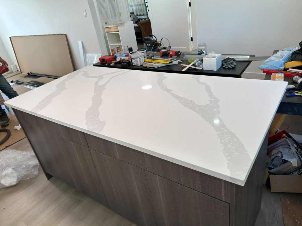 Marble-look quartz kitchen island installed in Calgary by Red Leaf Interior